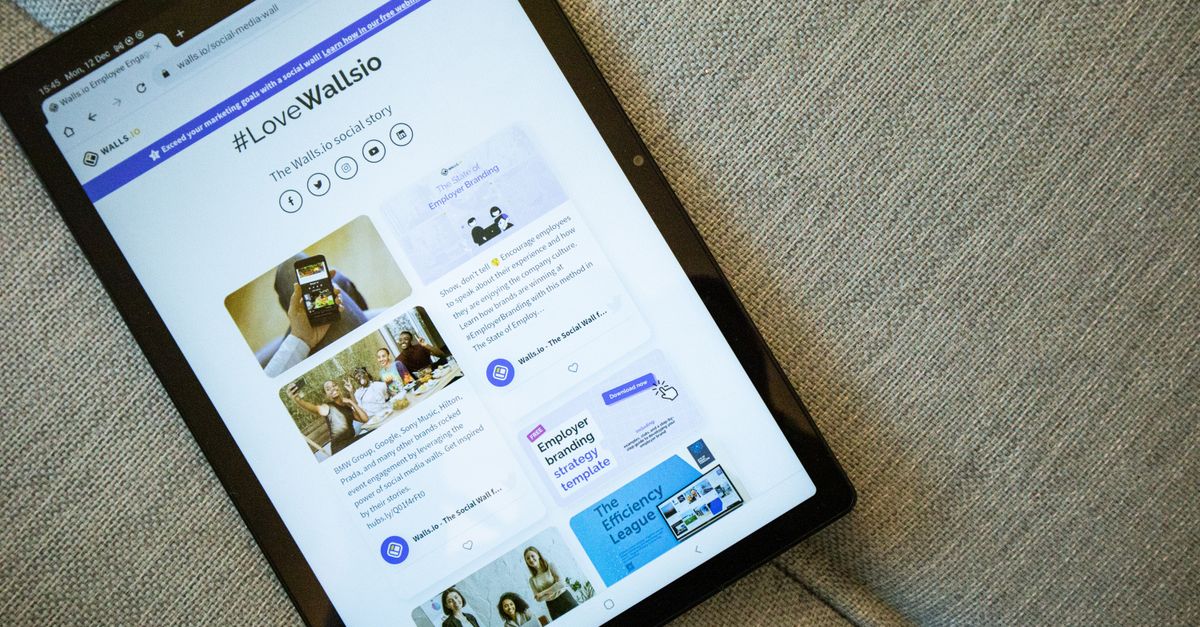 A tablet on a couch showing the Wallis.io website interface.